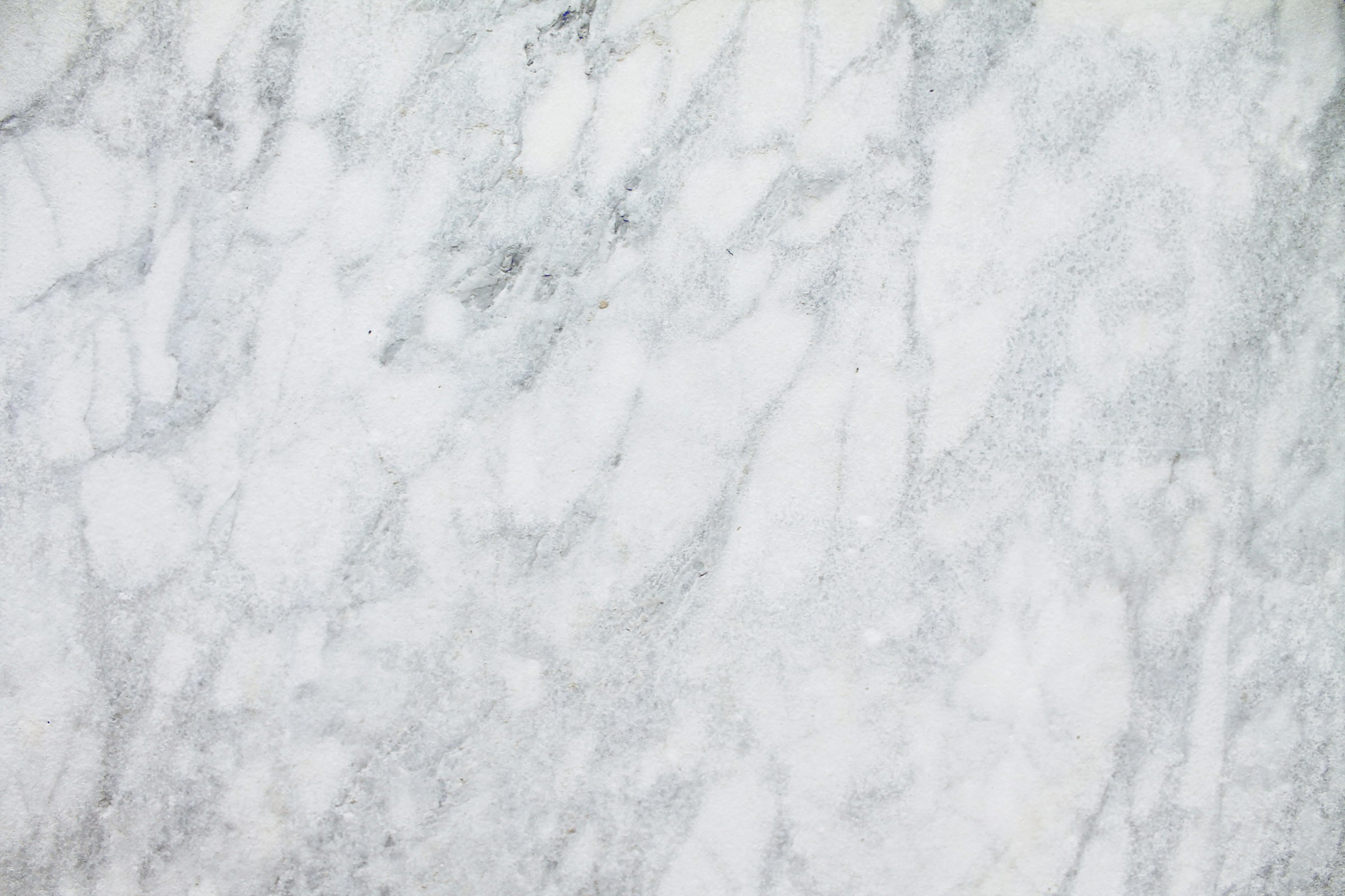 Large-format sintered stone slab surface with grey veining
